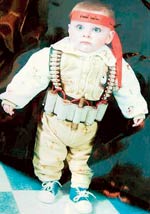 This little boys name is Bara'a Abu Turki, a name meaning 'innocence' in Arabic, his Father is an active member of the terror group Hamas and commissioned this photograph in a local studio, apparently such 'portraits' are not an uncommon occurence!